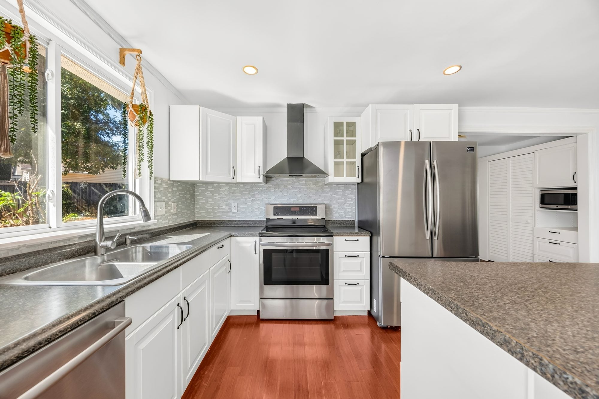 Kitchen with white cabinets and stainless appliances at 4900 Cricklewood Lane