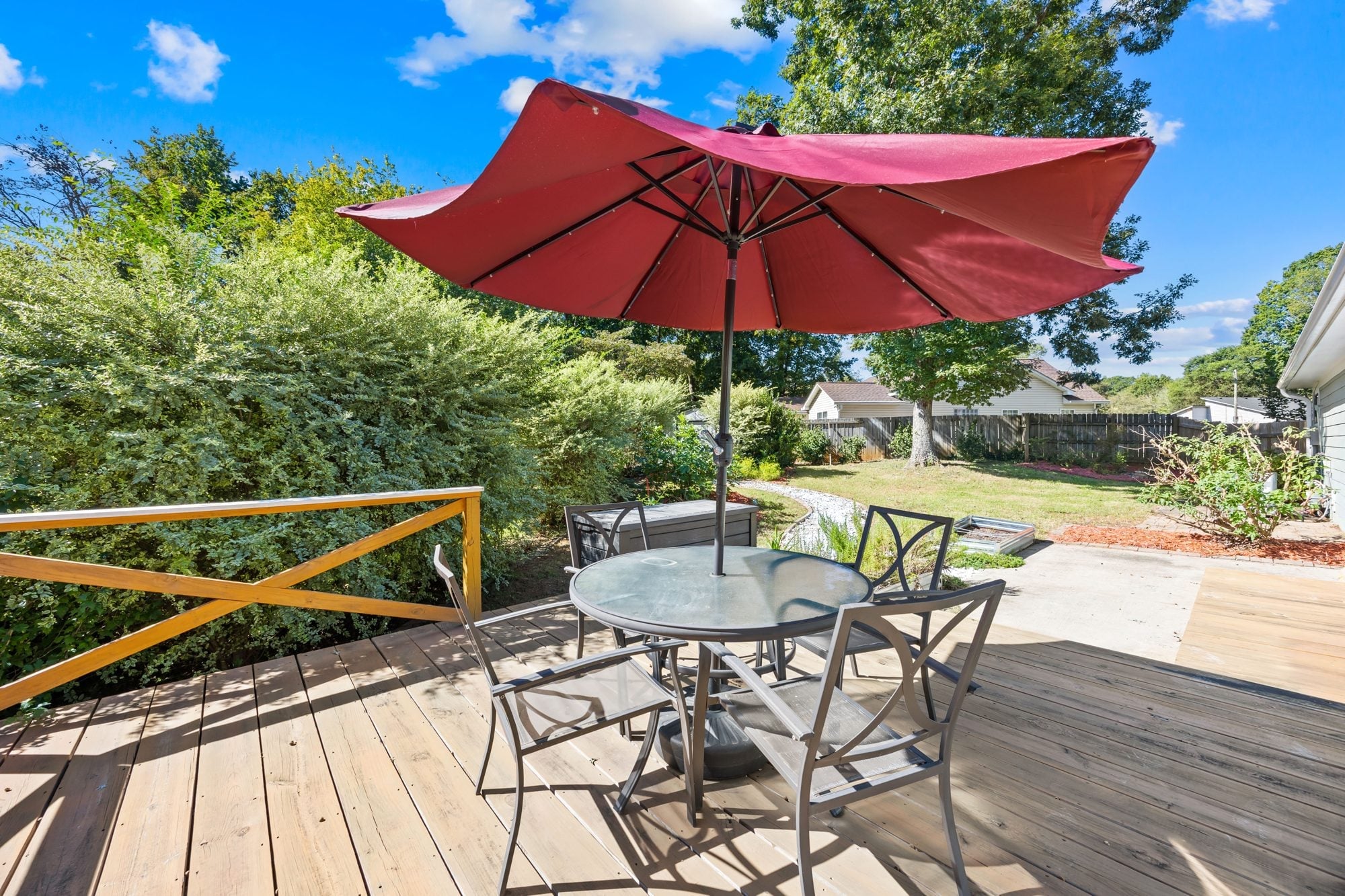 Wood deck with patio table at 4900 Cricklewood Lane