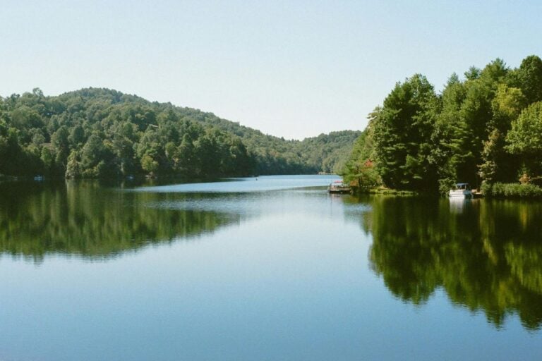 Calm river lined with wooded hills