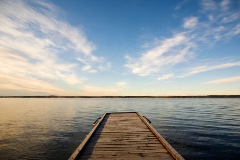 Wooden dock on a lake at sunset